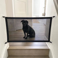 Cancelletto a rete per cani montato alla base delle scale con cane seduto